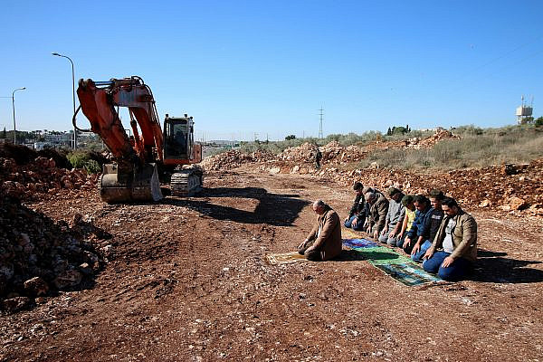 Palestinian residents of Kafr Laqef organize the Friday Muslim prayer on their lands to protest against the Israeli construction, December 20, 2019. (Ahmad Al-Bazz)