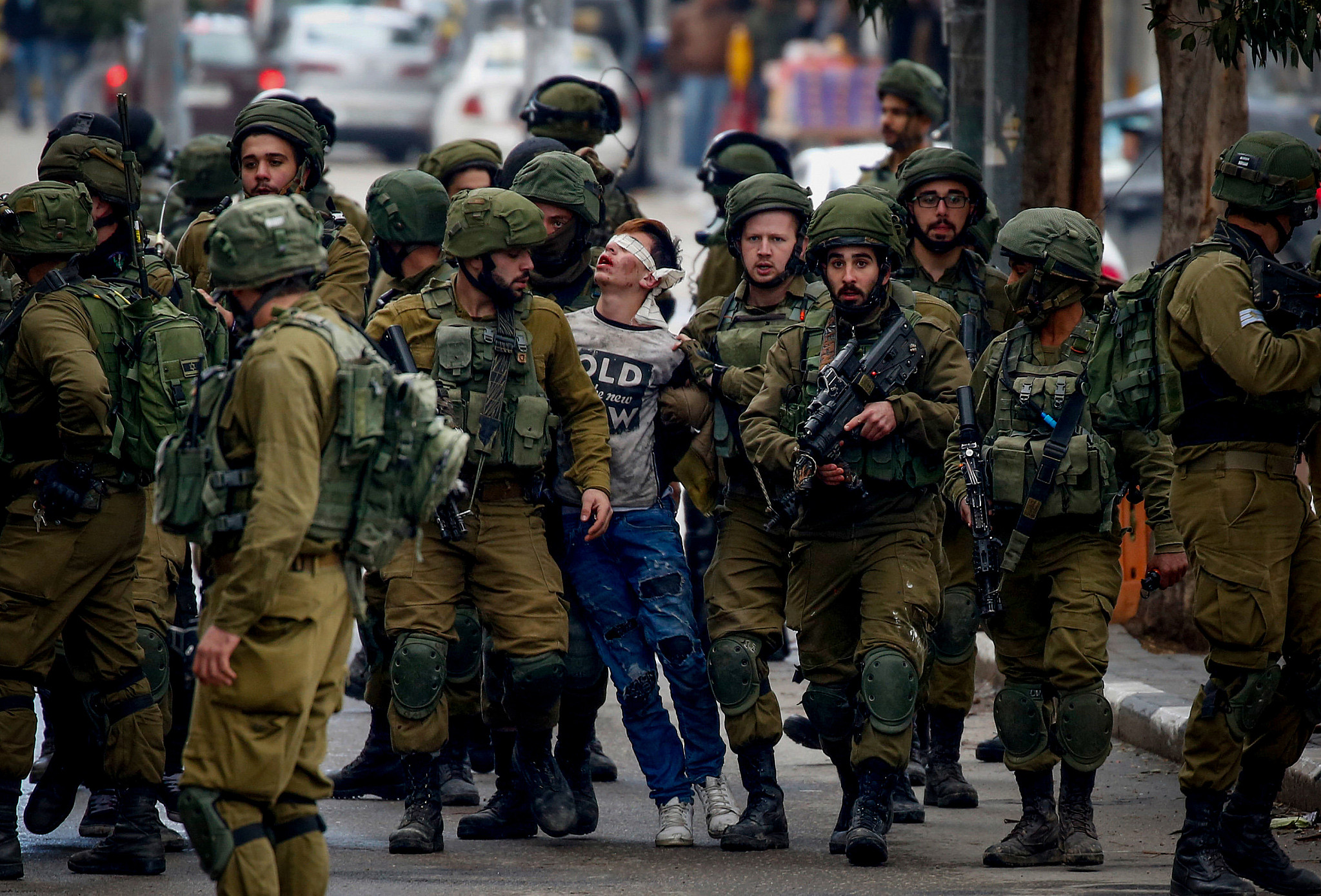 Israeli soldiers arrest a Palestinian youth during a protest against Donald Trump&#8217;s recognition of Jerusalem as Israel&#8217;s capital, Hebron, West Bank, December 7, 2017. (Wisam Hashlamoun/Flash90)