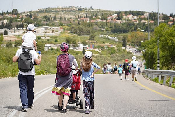 Jewish Israeli settlers marching near the settlement of Kedumim in the occupied West Bank, on April 25, 2019. (Hillel Maeir/Flash90)