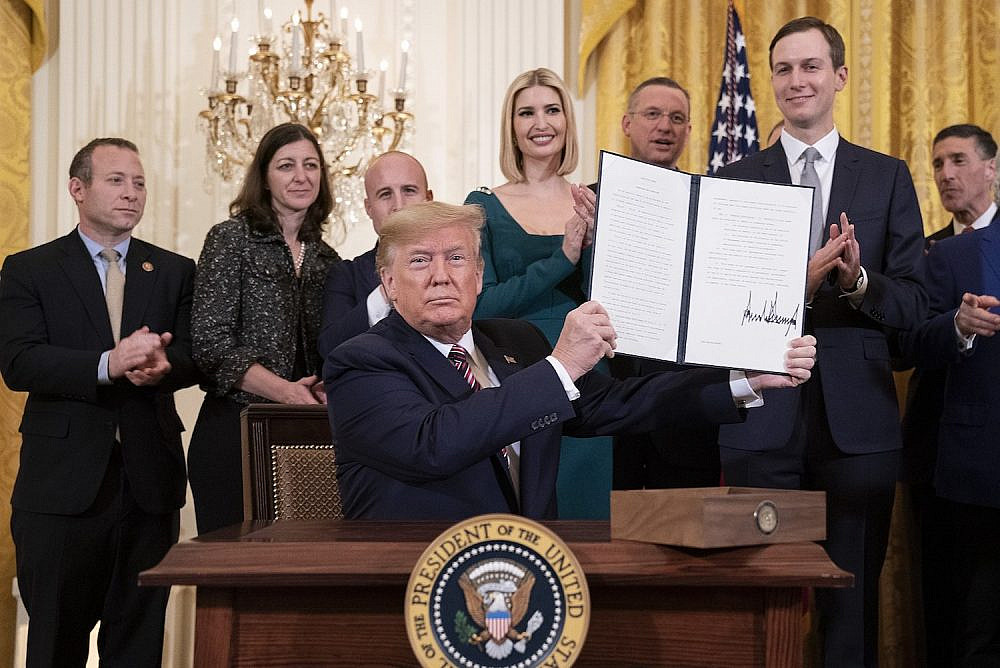 President Trump displays the controversial Executive Order on Combating Anti-Semitism during an afternoon Hanukkah reception alongside members of his administration, including son-in-law Jared Kushner, in the White House, December 11, 2019. (Joyce N. Boghosian/White House Photo)