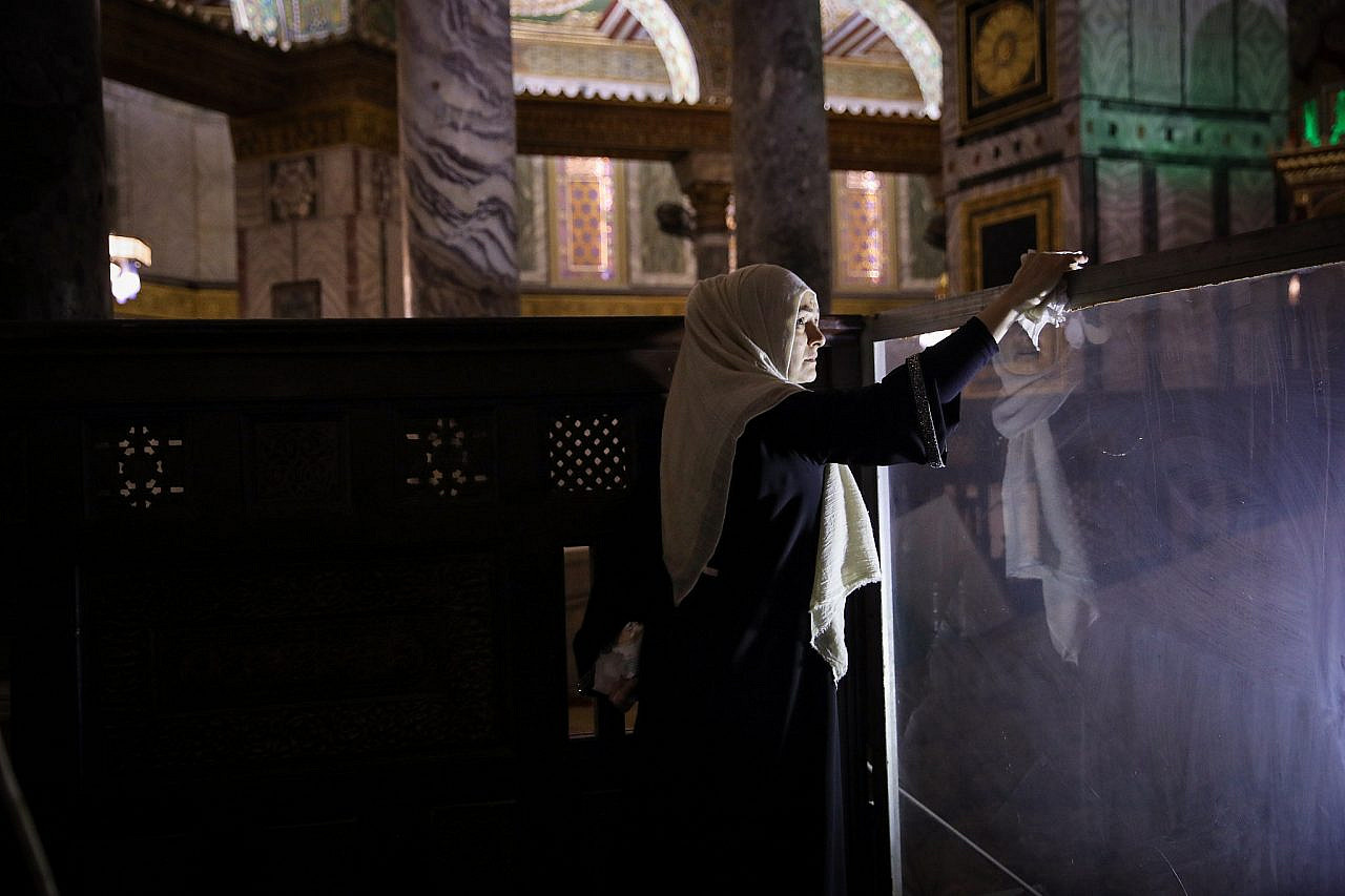 A Palestinian woman cleans inside the Dome of the Rock prior to Friday prayers, due to fear of the coronavirus, Jerusalem, March 5, 2020. (M Nazir/Flash90)