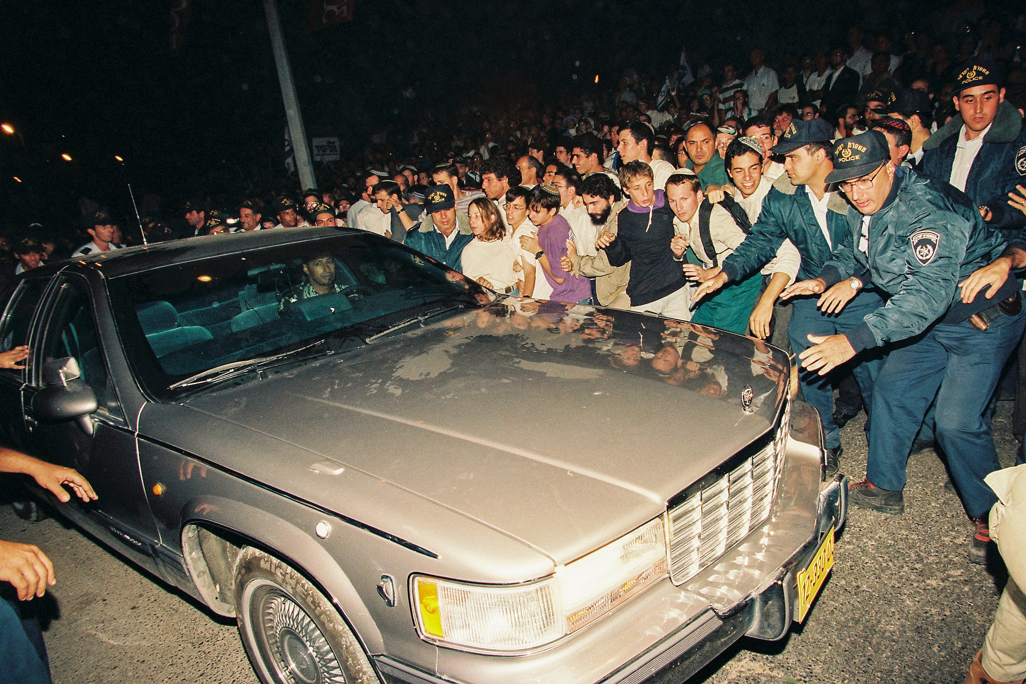 Israeli police try to prevent right-wing protesters demonstrating against the Oslo Accords from jumping on Israeli Prime Minister Yitzhak Rabin's car, Jerusalem, October 5, 1995. (Flash90)