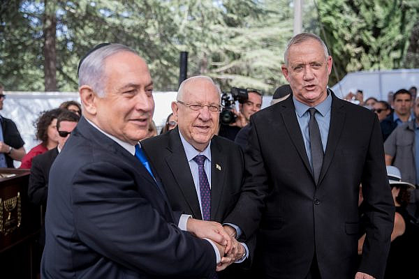 President Reuven Rivlin, Prime Minister Benjamin Netanyahu and Benny Gantz, shake hands at the memorial ceremony for the late President Shimon Peres, Jerusalem, September 19, 2019. (Yonatan Sindel/Flash90)