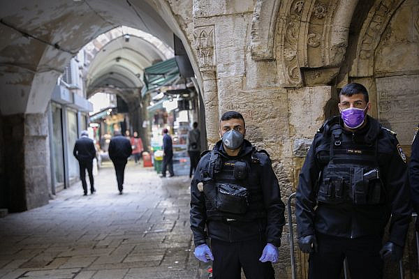 Israeli border police wear face masks as protection from the coronavirus as they stand guard in the Muslim quarters in Jerusalem's Old City. March 15, 2020. (Yossi Zamiri/Flash90)