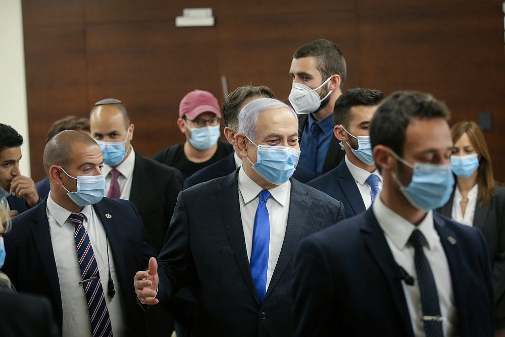 Israeli prime minister Benjamin Netanyahu walks in the Israeli parliament after presenting the 35th government of Israel to the Knesset, May 17, 2020. (Alex Kolomoisky/Pool)