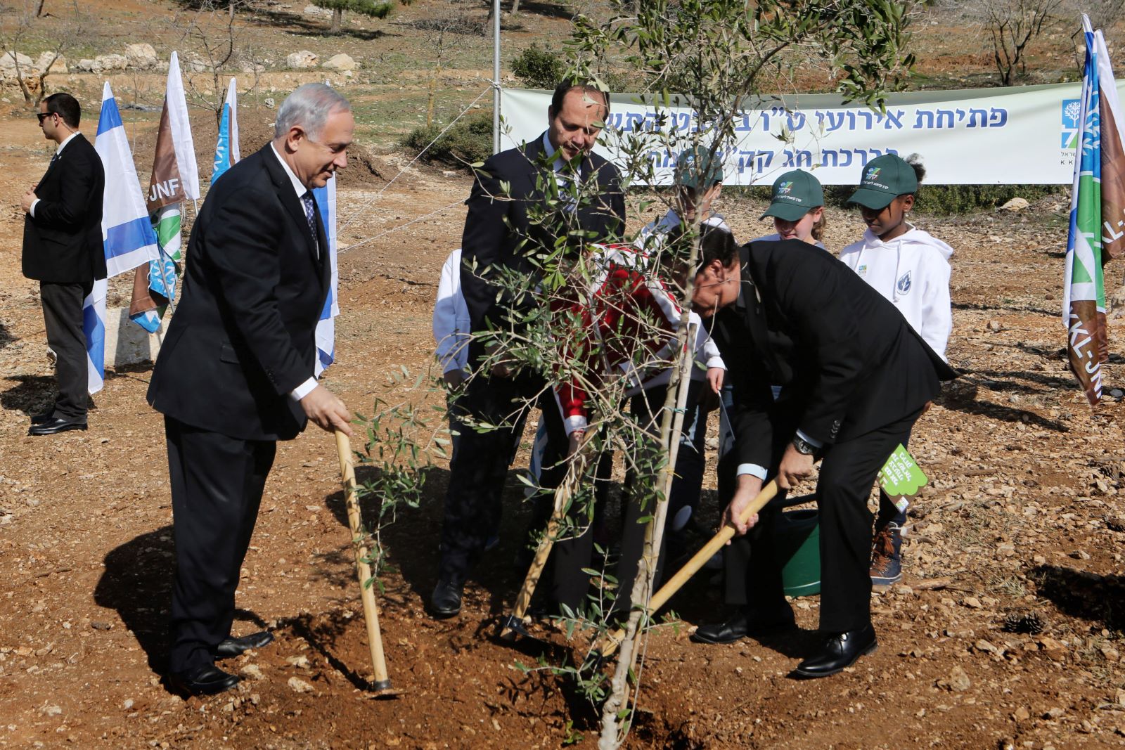 Israeli Prime Minister Benjamin Netanyahu, Jerusalem mayor Nir Barkat, and Effi Stenzler, chairman of the KKL-JNF, take part in a "Tu Bishvat" tradition of planting trees, in the Jerusalem forest on January 15, 2014. (Yossi Zamir/Flash 90)