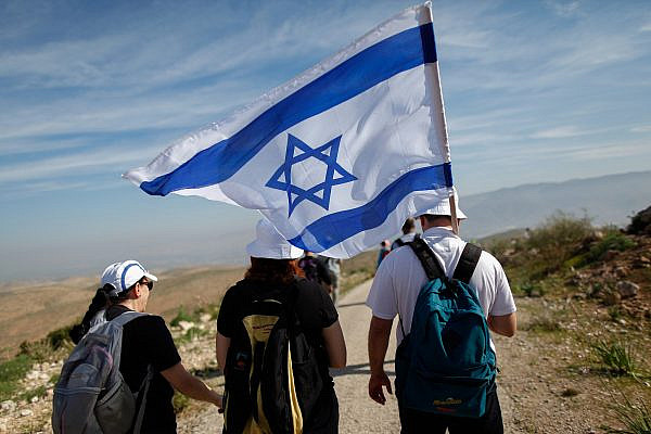 Israelis take part in an annual 8-km march in the Jordan Valley, led by then-Interior Affairs Minister Gideon Saar. February 21, 2014. (Yonatan Sindel/FLASH90)