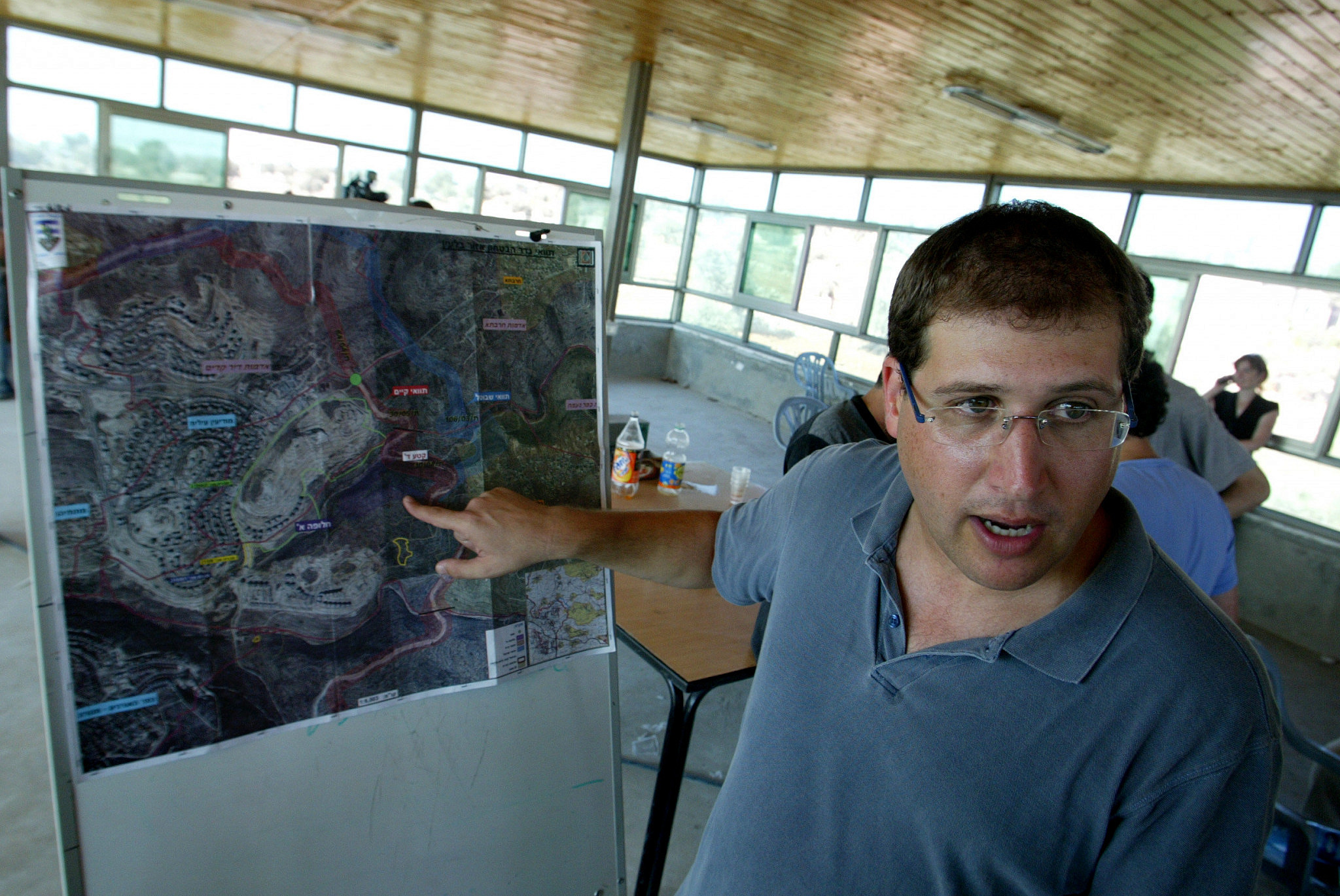 Israeli attorney Michael Sfard shows a map of the separation barrier following the decision by the Israeli Supreme Court to reroute its construction in the occupied West Bank village of Bil'in, September 4, 2007. (Olivier Fitoussi/Flash90)