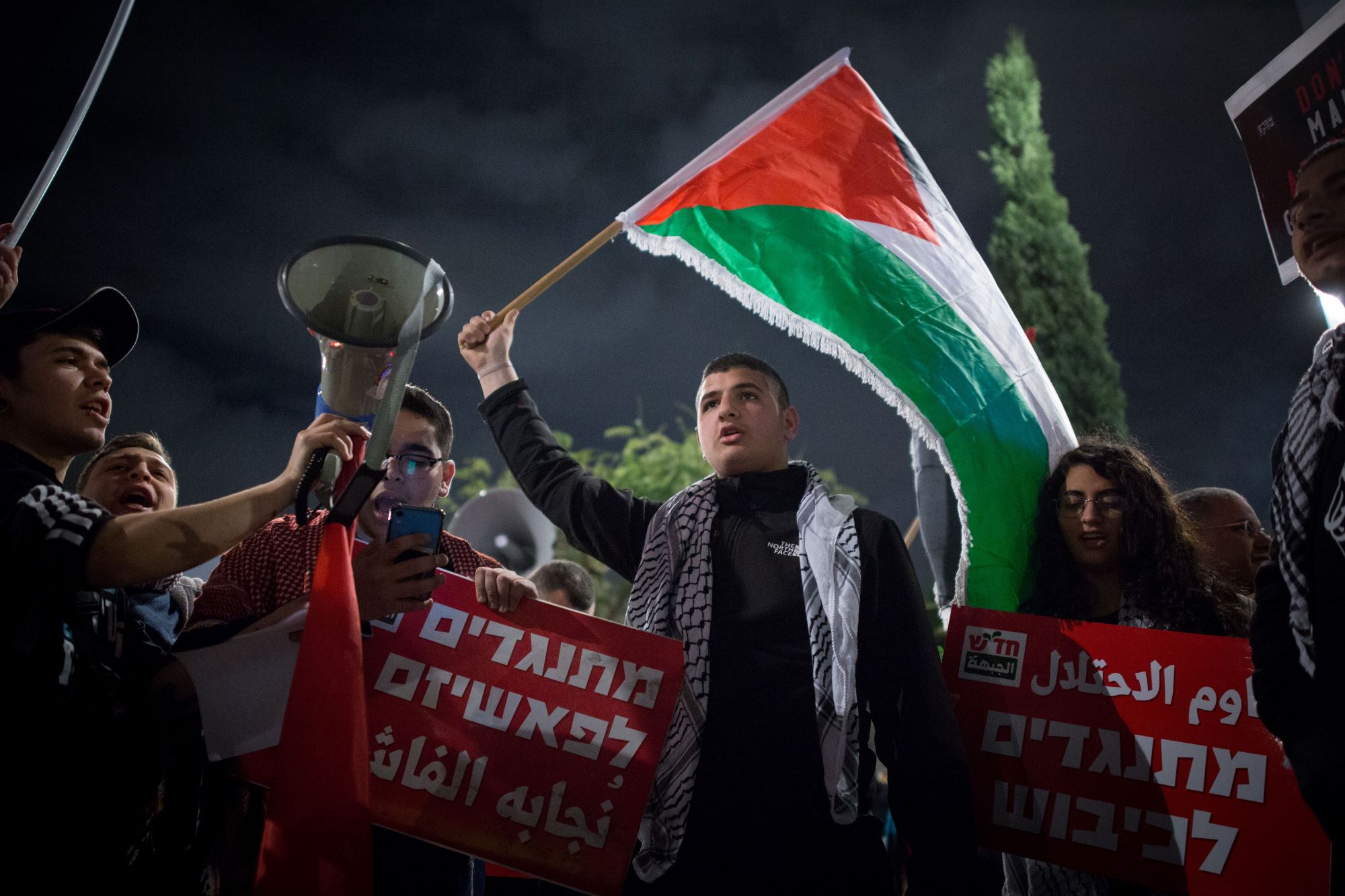 Palestinian activists demonstrate in a left-wing protest against US President Donald Trump's 'peace plan' in Tel Aviv, February 1, 2020. (Miriam Alster/Flash90)