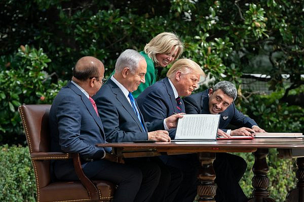 U.S. Chief of Protocol Cam Henderson assists President Donald Trump, Minister of Foreign Affairs of Bahrain Dr. Abdullatif bin Rashid Al-Zayani, Israeli Prime Minister Benjamin Netanyahu and Minister of Foreign Affairs for the United Arab Emirates Abdullah bin Zayed Al Nahyan with the documents during the signing of the Abraham Accords Tuesday, Sept. 15, 2020, on the South Lawn of the White House. (Official White House photo by Andrea Hanks)