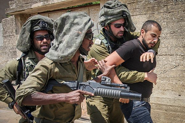 Israeli soldiers carry away a Palestinian protester in Kufr Qaddum, near Nablus in the occupied West Bank, August 23, 2019. (Nasser Ishtayeh/Flash90)