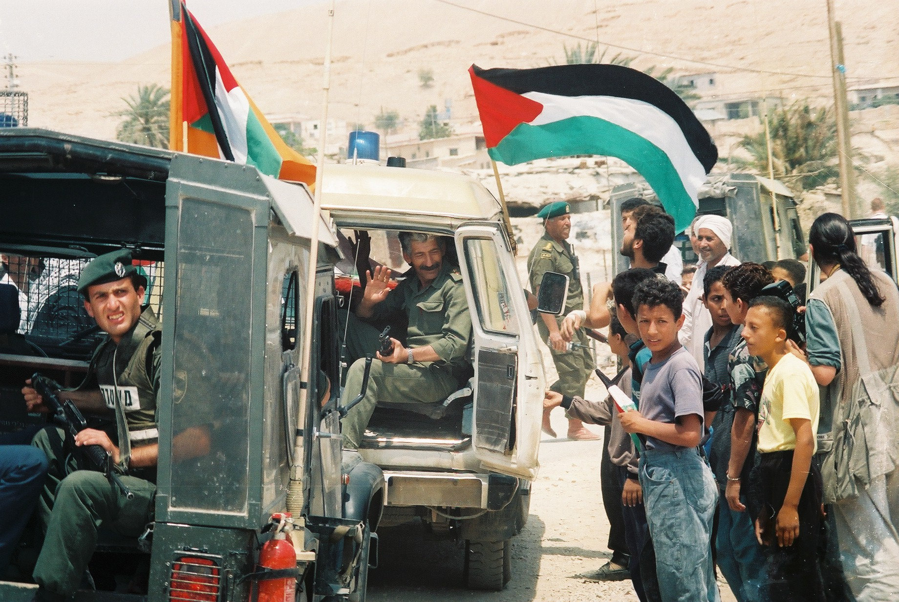 Palestinians celebrate the entrance of Palestinian police officers into Jericho, May 13, 1994. Jericho was one of the first cities in the occupied West Bank handed over to the Palestinian Authority in accordance with the Oslo Accords. (Yossi Zamir/Flash 90)