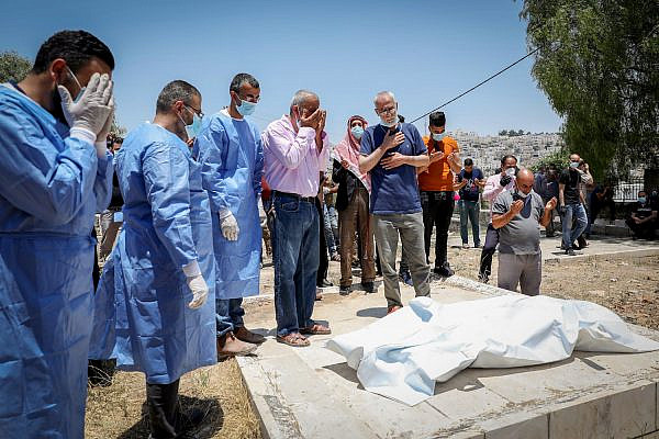 Palestinians attend the funeral of a family member who died after being infected with COVID-19, near the West Bank town of Hebron, July 5, 2020. (Wisam Hashlamoun/Flash90)