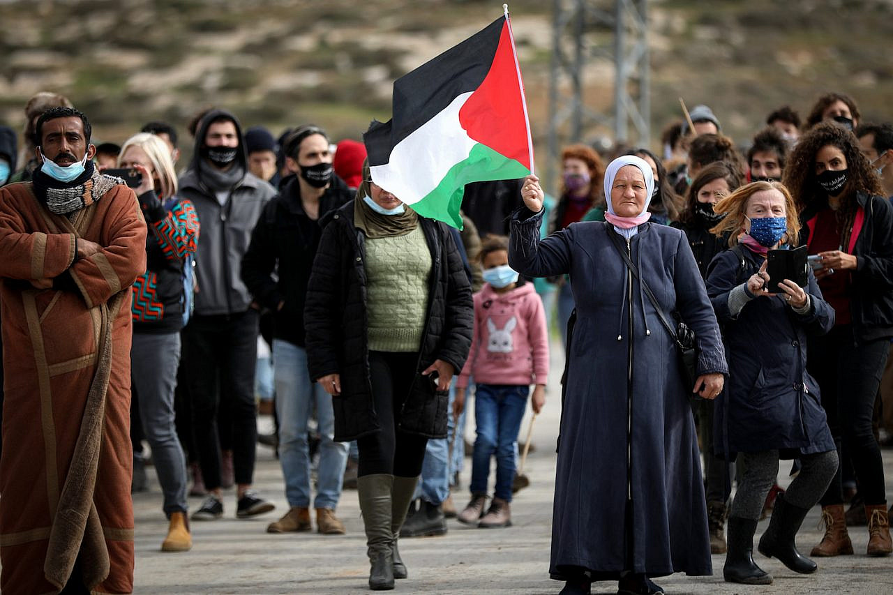 Palestinian demonstrators argue with Israeli soldiers during a protest against Israeli settlements in the South Hebron Hills, West Bank, January 15, 2021. (Wisam Hashlamoun/Flash90)