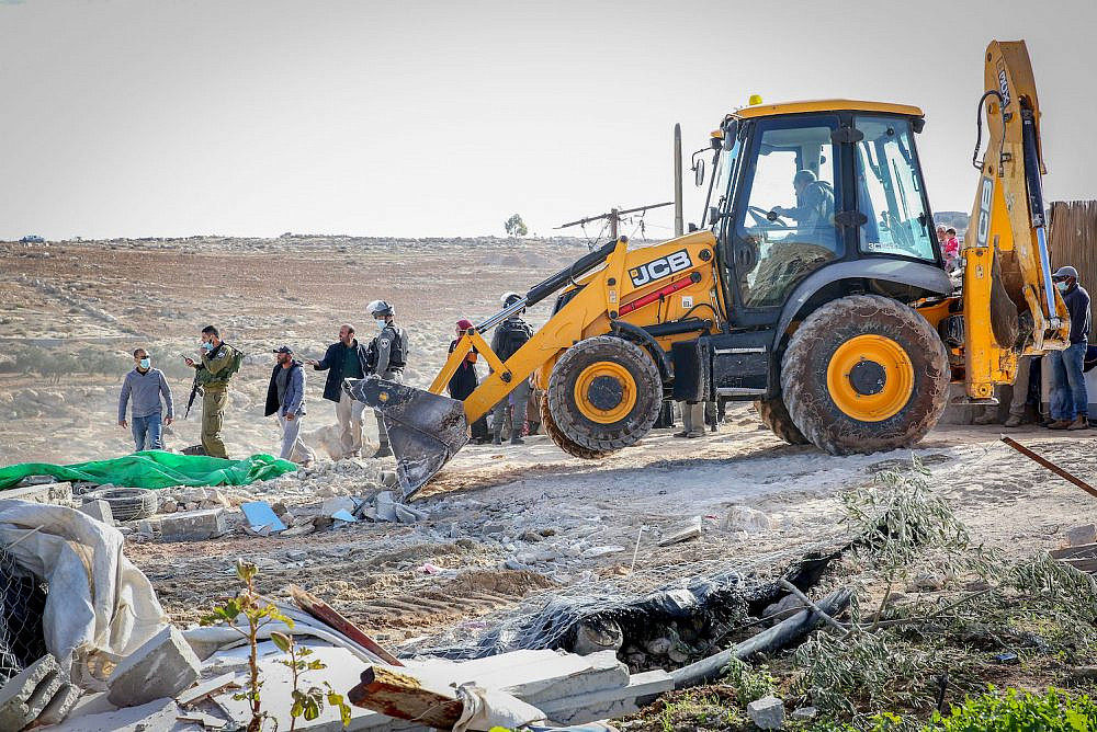 Israeli authorities demolish a tent in the West Bank area of Masafer, near the city of Yatta in the South Hebron Hills, on November 25, 2020. (Wissam Hashlamon/Flash90)