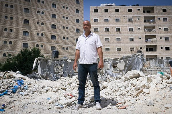 Ihab Hassan Ali stands on the remains of his family home in Shuafat Refugee Camp, East Jerusalem. (Rachel Shor)