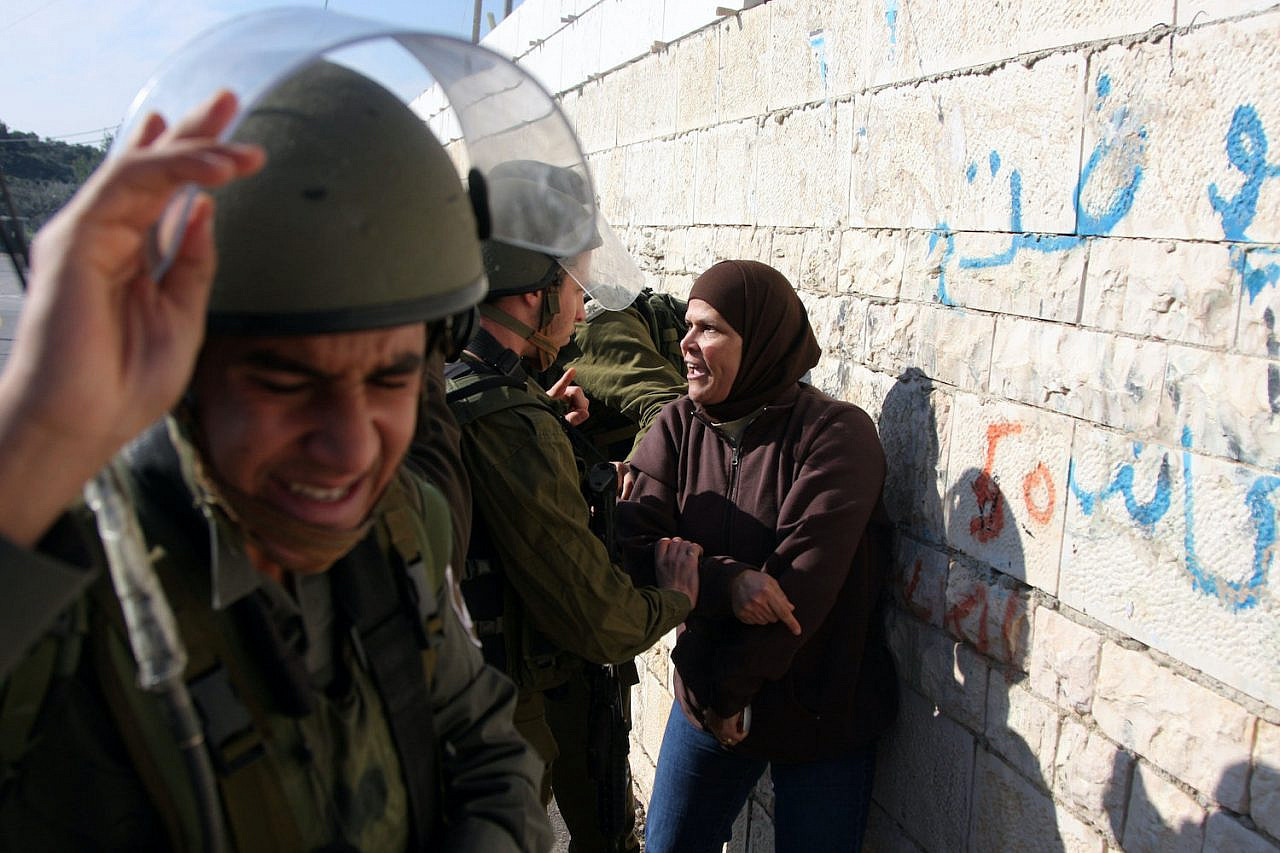 Israeli Border police officers detain a Palestinian demonstrator during a protest against Israel's separation barrier in the West Bank village of Nabi Saleh on January 22, 2010. (Issam Rimawi/Flash90)