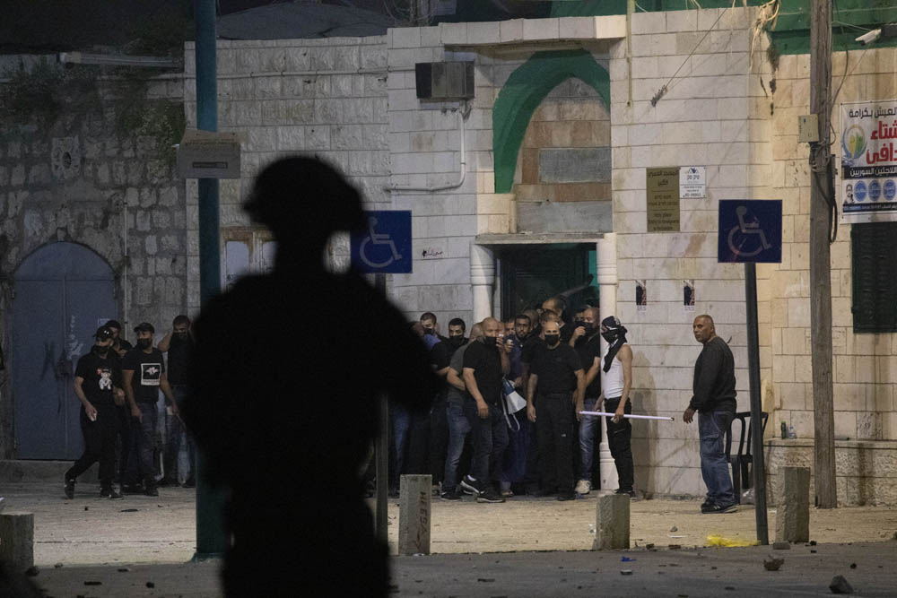 Palestinian residents of Lyd protect a local mosque during confrontations with Border Police officers and extremist settlers, May 13, 2021. (Oren Ziv)