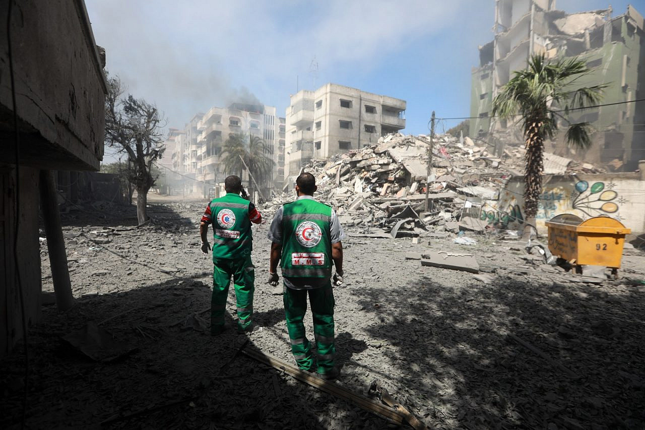 Medics with the Palestinian Red Crescent assessing damage after an Israeli airstrike in Gaza, May 7, 2021. (Mohammed Zaanoun/Activestills)