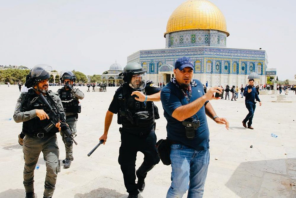 Israeli police beat Palestinian journalist Ahmad Gharabli at Al-Aqsa Mosque compound in Jerusalem, on May 21, 2021. (Suliman Khader)