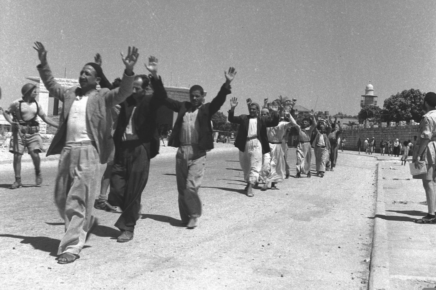Palestinians surrender after Israeli troops capture the Palestinian city of Ramla during the 1948 war, July 11, 1948. (David Eldan)