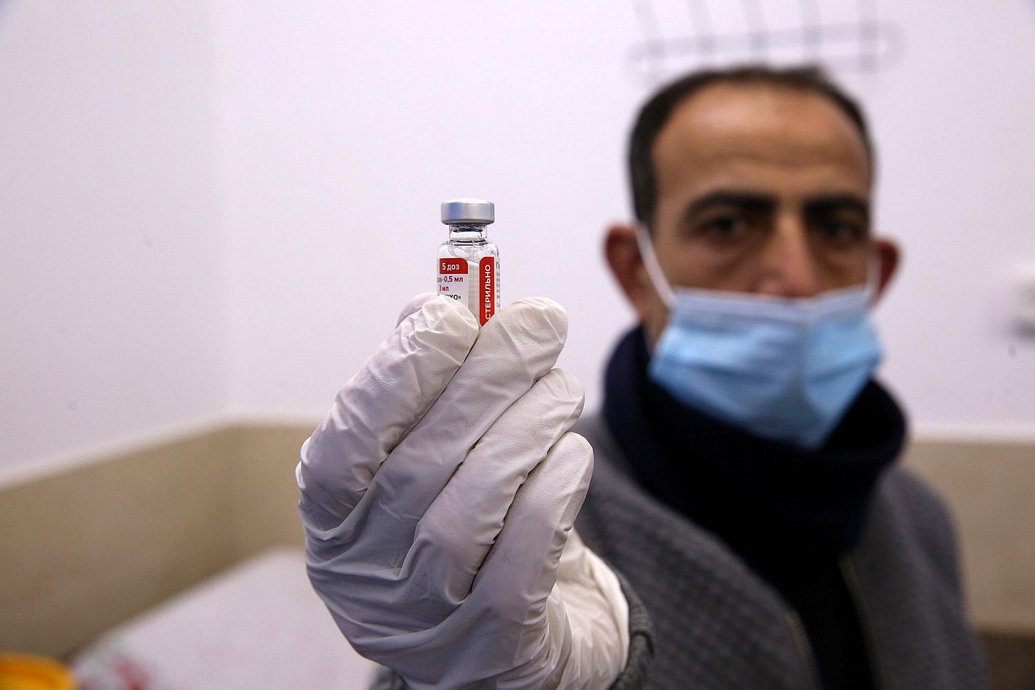 Palestinian medical workers receive Sputnik V vaccine against Covid-19 in a Palestinian Red Crescent Hospital in the West Bank city of Hebron, March 4, 2021. (Wissam Hashlamoun/Flash90)