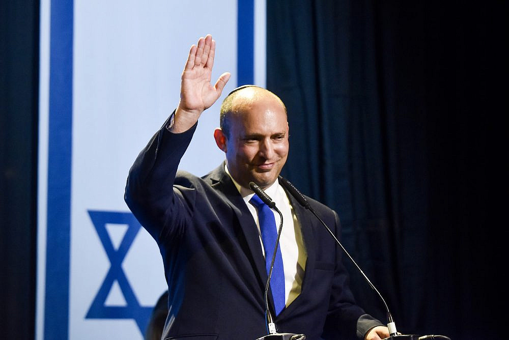 Naftali Bennett, head of Yamina party and party members seen with Yamina supporters at the party headquarters in Petah Tikva, on elections night, on March 23, 2021. Photo by Avi Dishi/Flash90