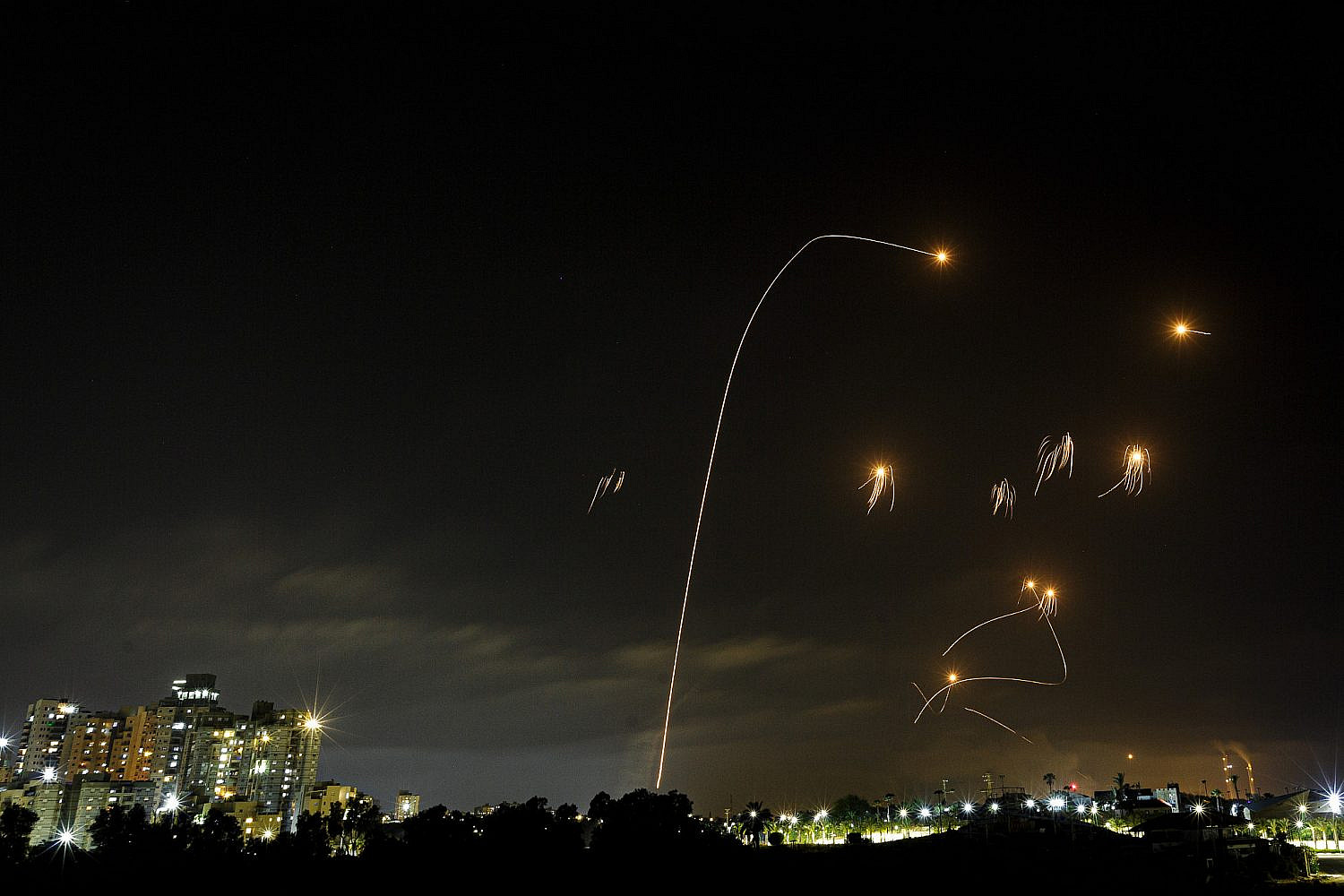 A long exposure picture shows the Iron Dome anti-missile system firing interception missiles as rockets fired from the Gaza Strip to Israel, seen from the southern Israeli city of Ashkelon, May 10, 2021. (Edi Israel/Flash90)
