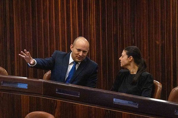 Prime Minister Naftali Bennett sits with Labor Party head Merav Michaeli in the plenum hall of the Knesset, Jerusalem, June 2, 2021. (Olivier Fitoussi/Flash90)