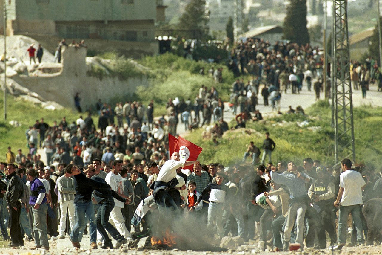 Palestinians throw rocks at a demonstration during the Second Intifada, March 25, 2001. (Nati Shohat/Flash90)