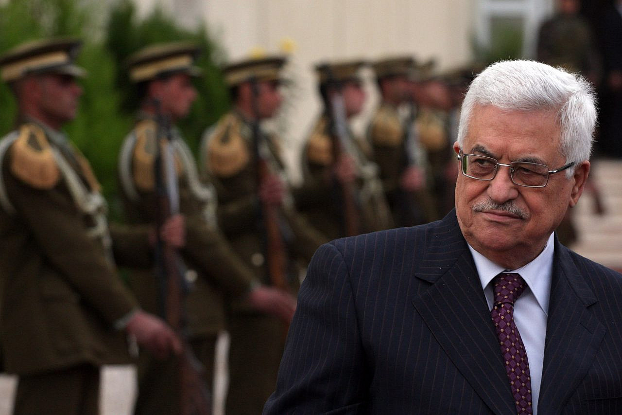 Palestinian President Mahmoud Abbas stands near the guard of honor outside his office in the West Bank city of Ramallah, Jan. 12, 2010. (Issam Rimawi/Flash90)