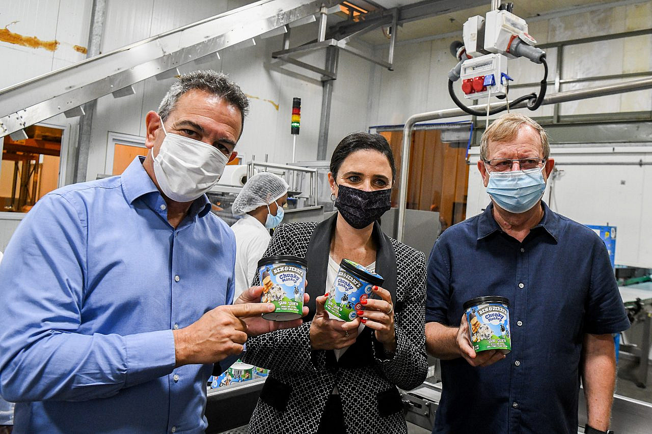 Israeli Interior Minister Ayelet Shaked tours the Ben and Jerry's factory near Kiryat Malakhi, with the CEO of the company's Israel distributor Avi Zinger (r), July 21, 2021. (Flash90)