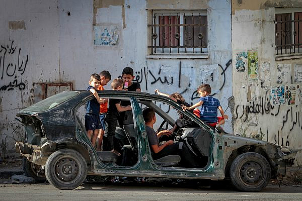 Palestinian children play on an empty street during a strike in Jenin, West Bank, in solidarity with Palestinian prisoners in Israeli prisons, September 11, 2021. (Nasser Ishtayeh/Flash90)