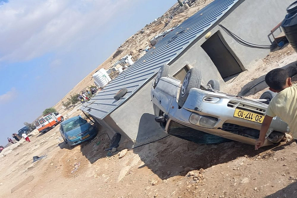 A car seen overturned during a settler attack on the Palestinian village of Mufagara in the South Hebron Hills. Sixty masked settlers attacked people, homes, and cars, September 28, 2021. (Alliance for Human Rights)