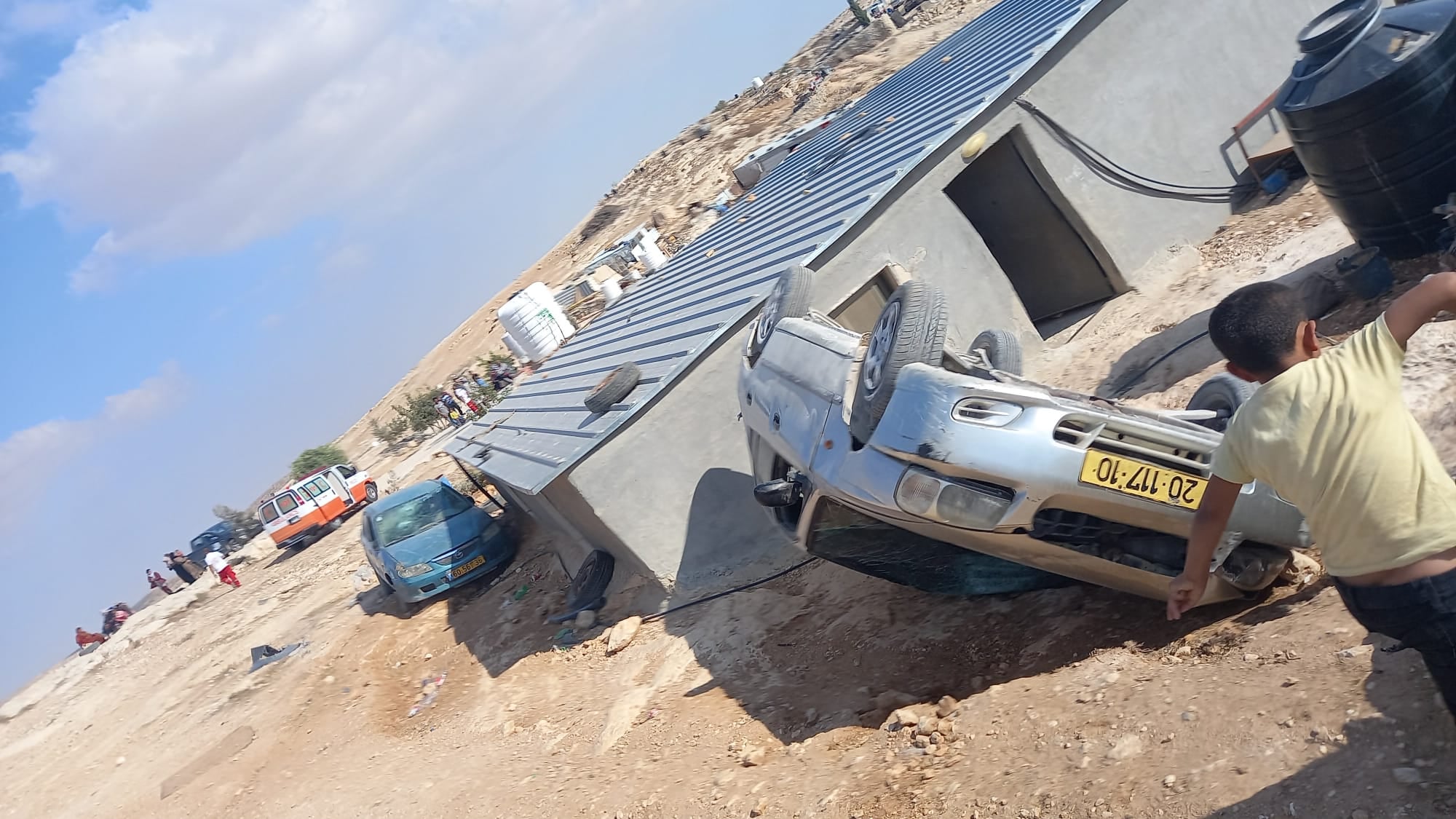 A car seen overturned during a settler attack on the Palestinian village of Mufagara in the South Hebron Hills. Sixty masked settlers attacked people, homes, and cars, September 28, 2021. (Alliance for Human Rights) 