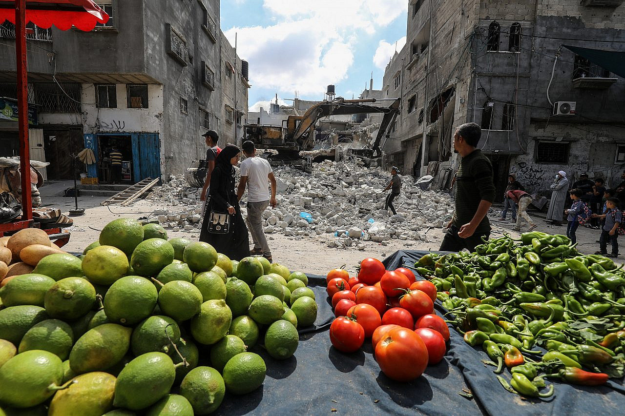 Workers remove the rubble of a destroyed building in Rafah in the Gaza Strip after it was hit by Israeli air strikes during the latest assault on the strip, September 29, 2021. (Abed Rahim Khatib/Flash90)