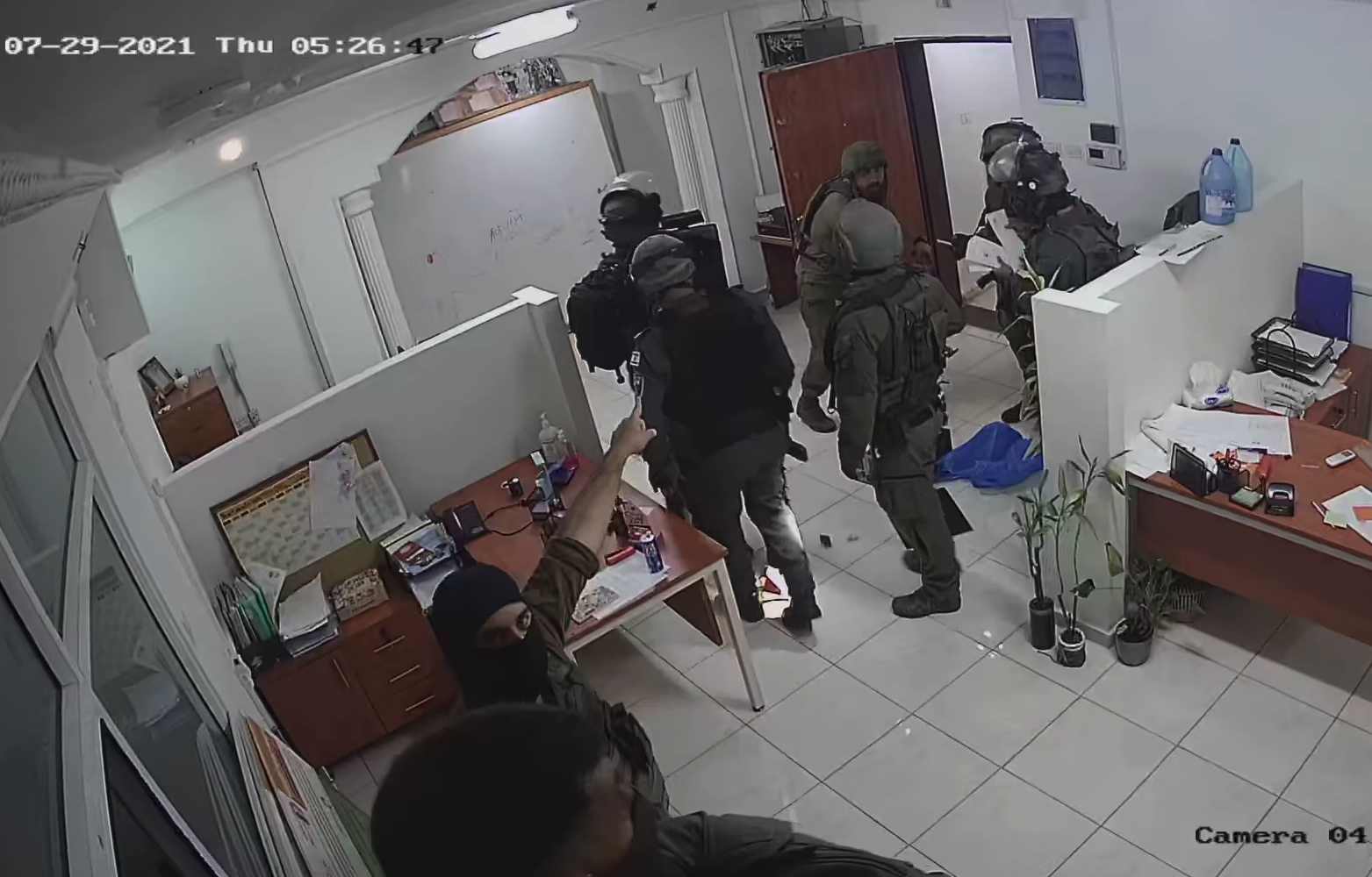Israeli soldiers confiscate computer equipment and client files in a raid on the offices of Defense for Children International - Palestine, Al-Bireh, West Bank, July 29, 2021. (DCI-P)