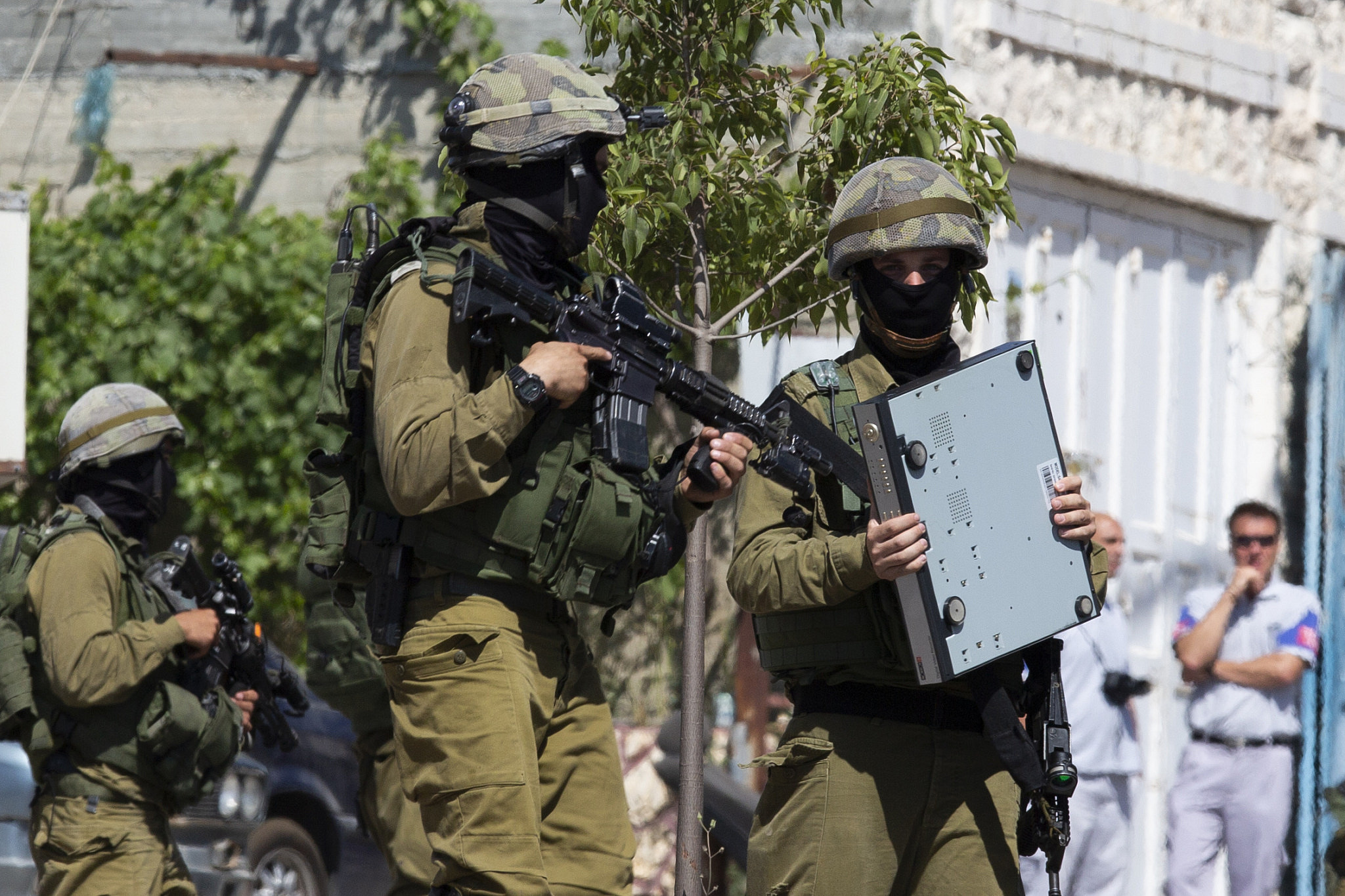 Illustrative photo of Israeli soldiers taking part in a raid on the West Bank city of Hebron, June 18, 2014. (Oren Ziv)