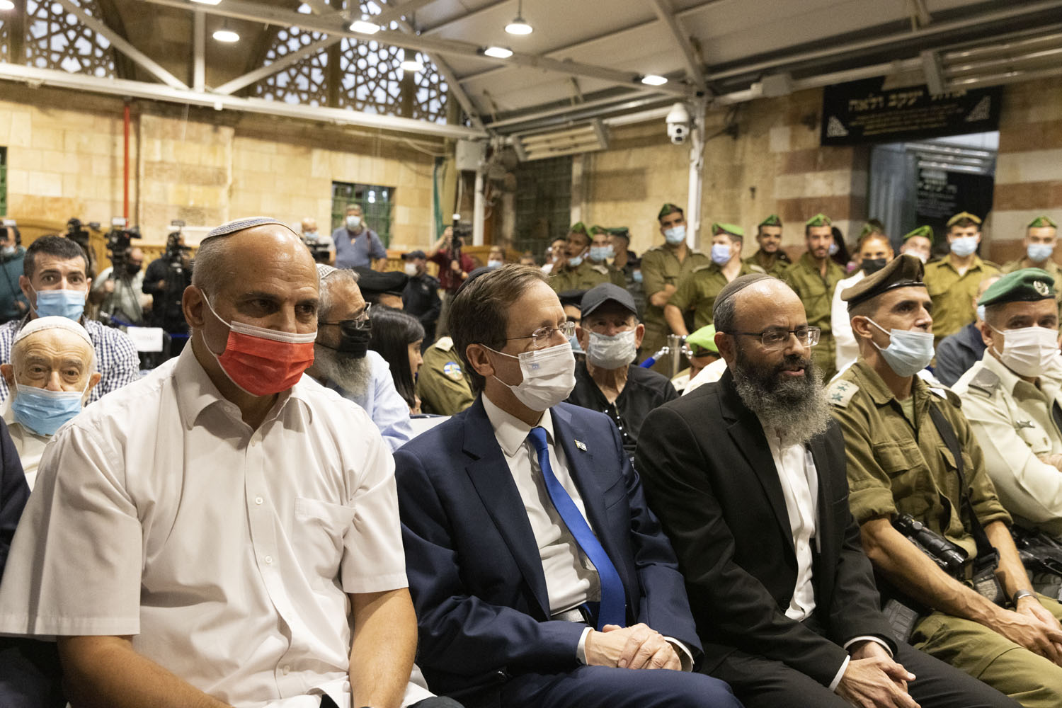Israeli President Isaac Herzog attends a ceremony marking the first night of Hanukkah in the Tomb of the Patriarchs/Ibrahimi Mosque in the Old City of Hebron, occupied West Bank, Nov. 28, 2021. (Oren Ziv)