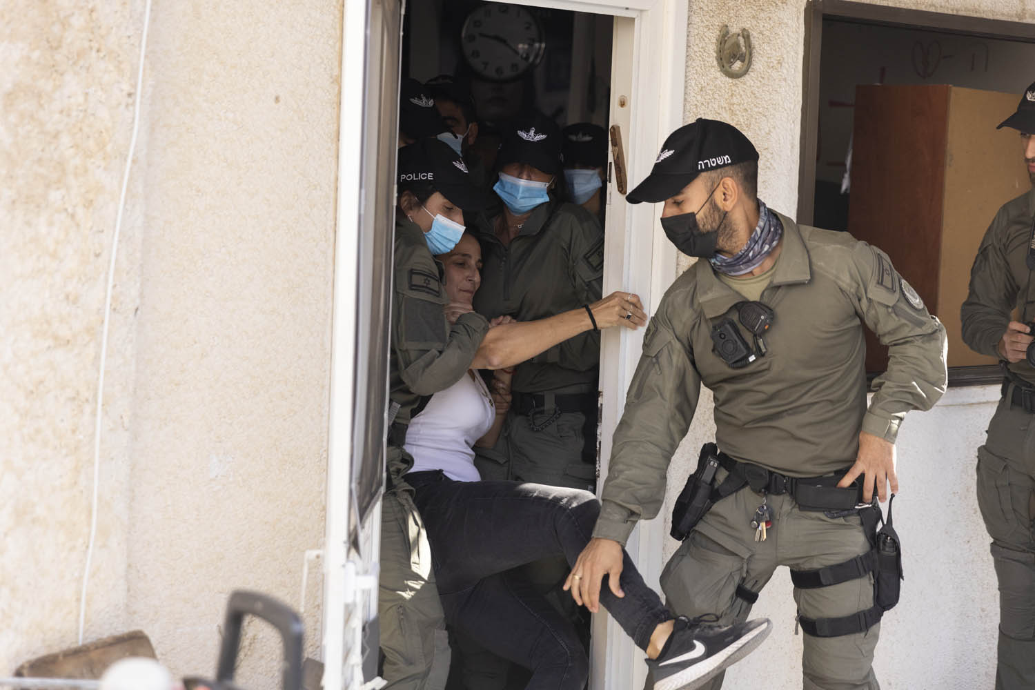 Israeli police remove a resident of Givat Amal from her home, Tel Aviv, November 15, 2021. (Oren Ziv/Activestills.org)