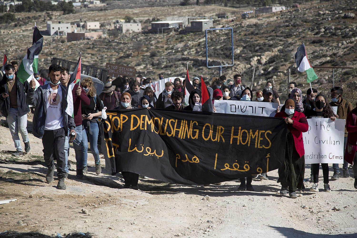 Protesters march in A-Rakeez, Massafer Yatta area, South of Hebron, towards the Avigail outpost, one week after 24-year-old Harun Abu Aram was shot in the neck while attempting to stop Israeli soldiers from confiscating a neighbor’s generator. January 8, 2021. (Keren Manor/Activestills)