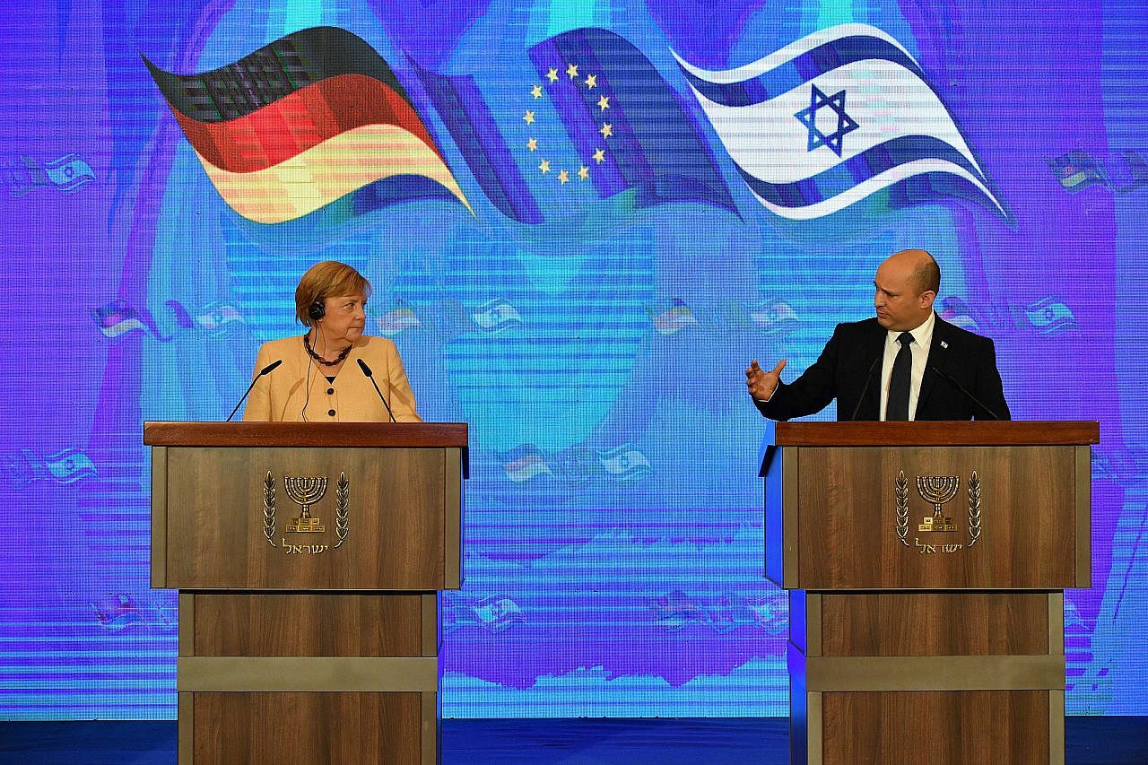 Israeli Prime Minister Naftali Bennett and German Chancellor Angela Merkel hold a joint press conference at the King David Hotel, Jerusalem, October 10, 2021. (Yoav Dudkevitch/POOL)
