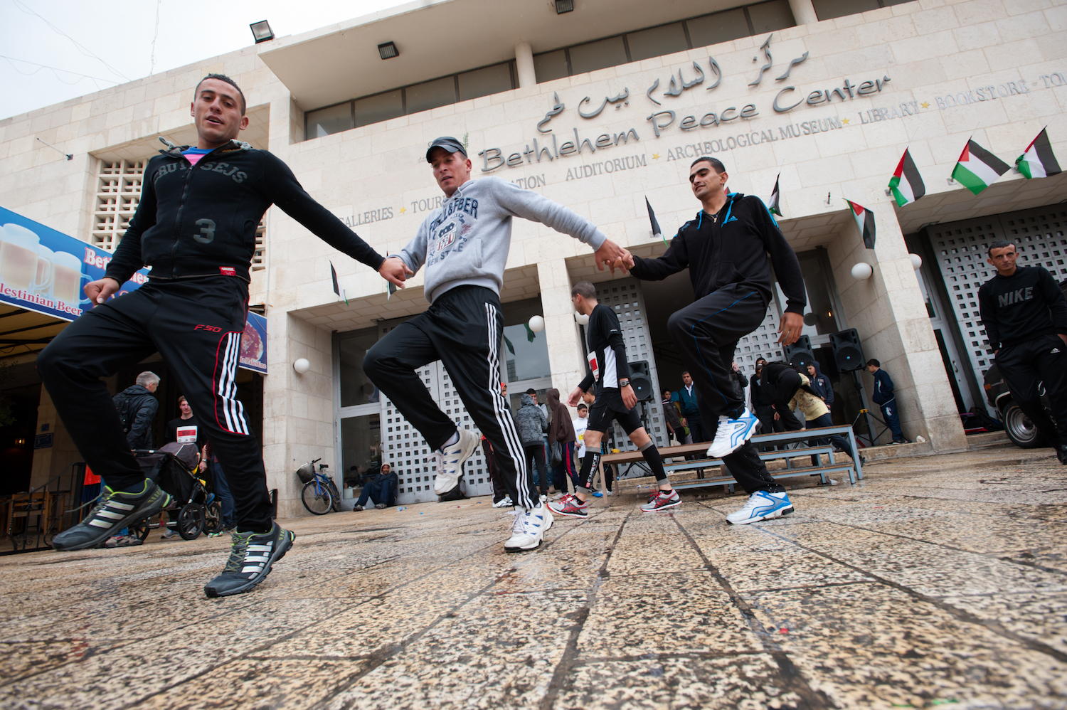 Palestinian men perform the traditional 'dabke' dance to celebrate the completion of the inaugural Palestine Marathon, April 21, 2013. (Ryan Rodrick Beiler/Activestills.org)