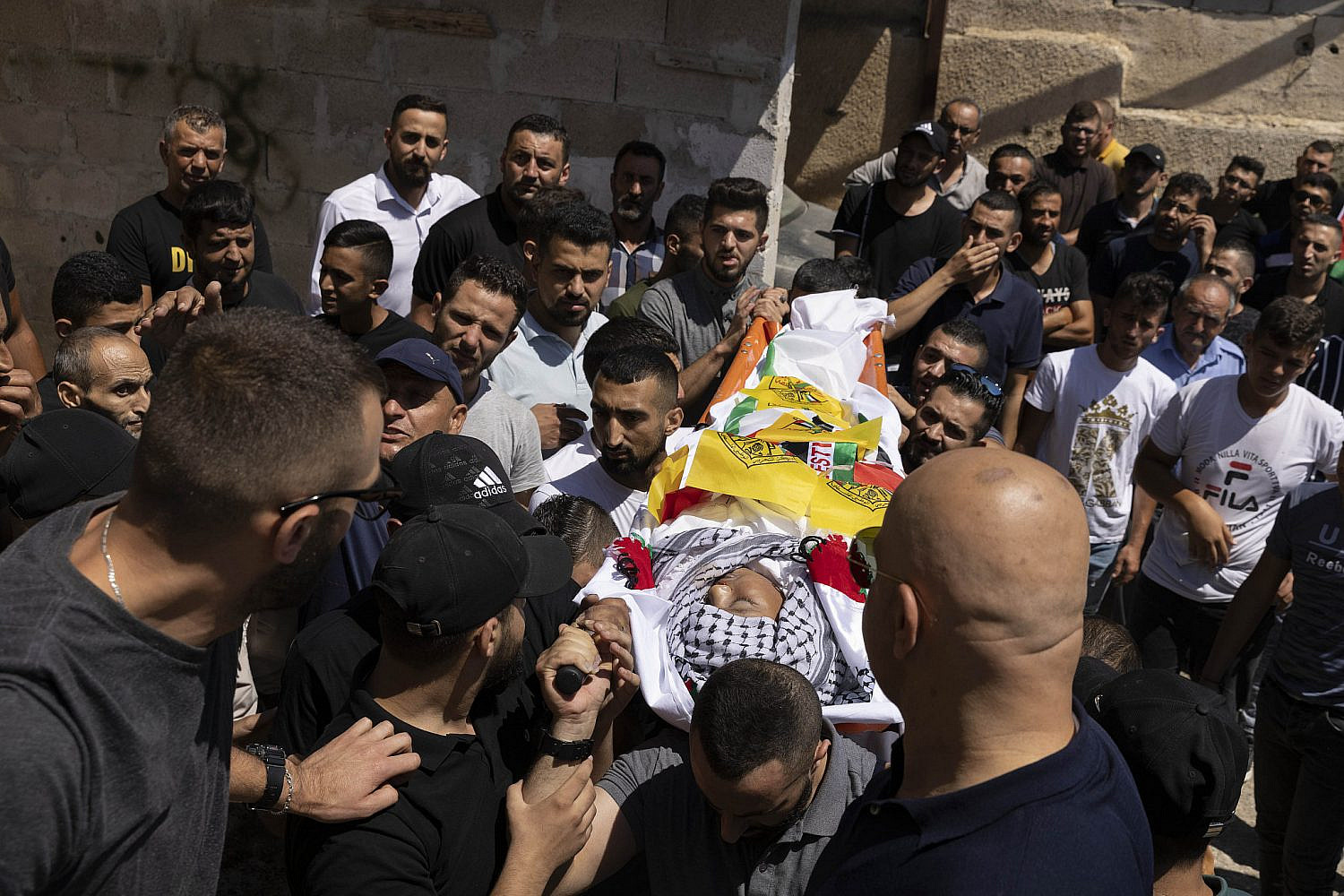 Funeral of 12-year-old Mohammed al Alami, in the village of Beit Ummar, north of Hebron. Alami was shot by Israeli soldiers while sitting in the passenger side of his family's car as he and his father returned from buying vegetables. July 29, 2021. (Oren Ziv/Activestills)