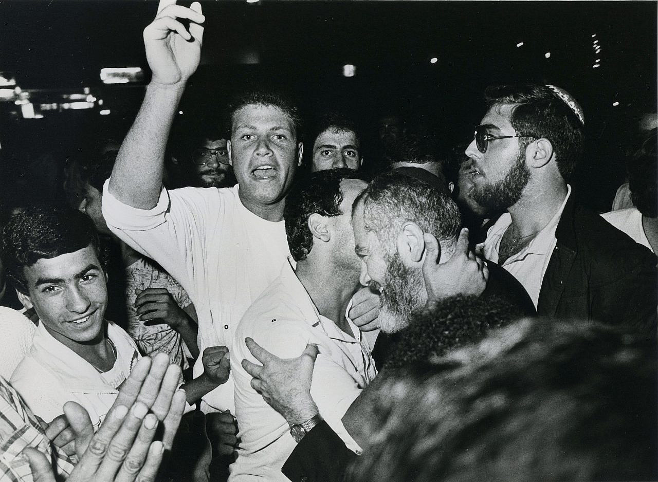Rabi Meir Kahane (second from right) is embraced by his supporters in Israel, 1985. (Moshe Shai/Flash90)