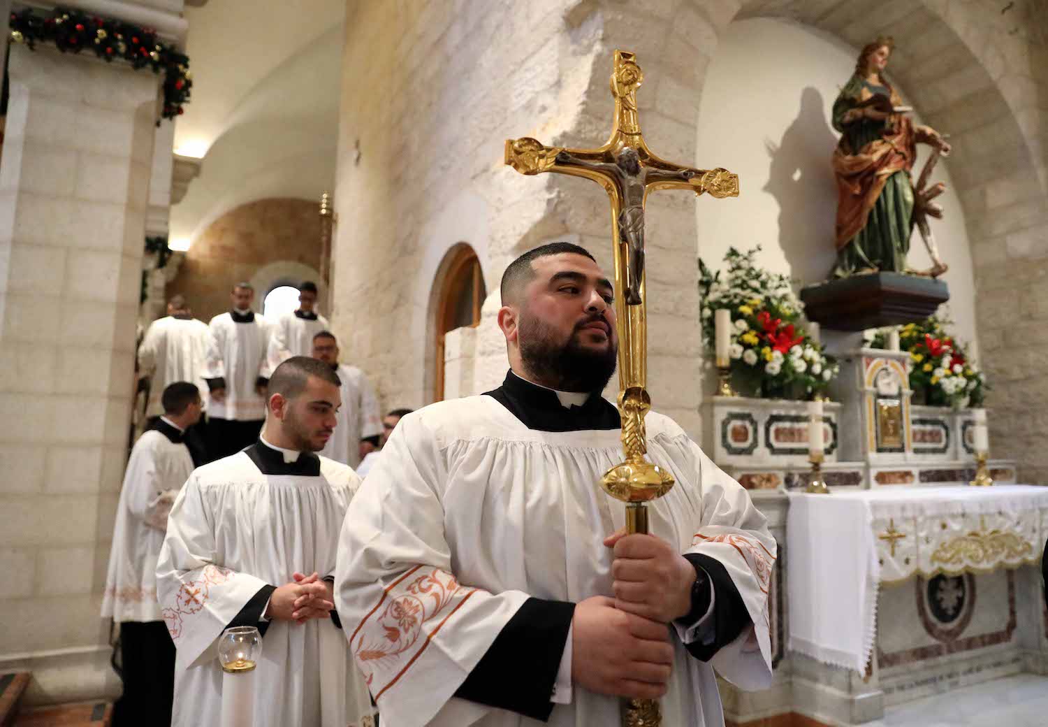 Latin Patriarch Pierbattista Pizzaballa, the top Catholic clergyman in the Holy Land (center) leads the Christmas morning Mass at the Church of the Nativity, Bethlehem, West Bank, December 25, 2021. (Wisam Hashlamoun/Flash90)