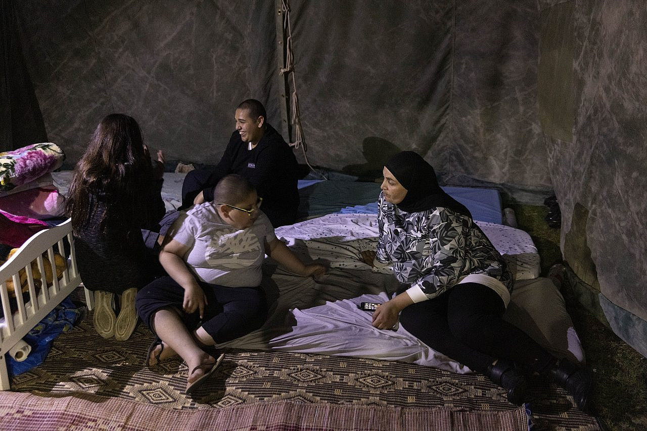 Farida Najar and her children at a protest tent camp organized by single Palestinian mothers in Jaffa who are demanding public housing, November 17, 2021. (Oren Ziv)