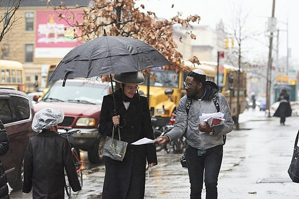 JFREJ members handing out pamphlets during a "Day Against Hate" event, New York City, March 16, 2020. (JFREJ)