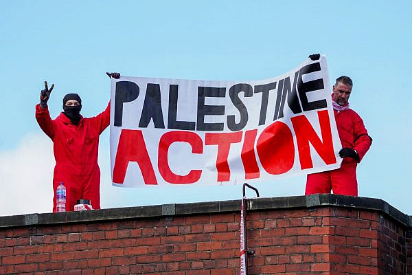Activists from Palestine Action hold up a banner on top of Elbit Systems factory in Oldham, northern England, August, 2021. (Palestine Action)