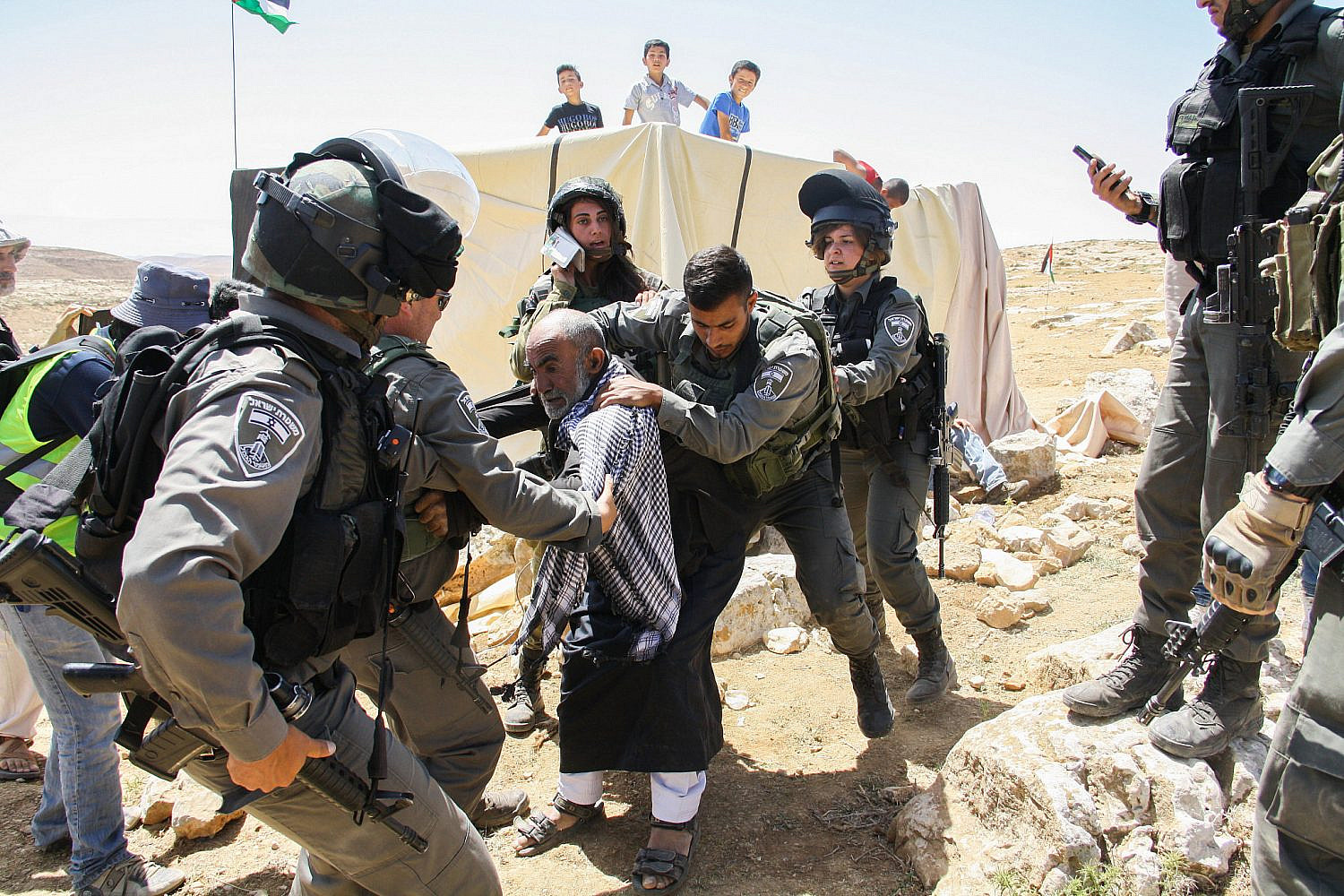 Israeli Border Police officers arrest a Palestinian Bedouin man at the Surora village near the West Bank village of Yatta, south of Hebron, May 25, 2017. (Wisam Hashlamoun/Flash90)